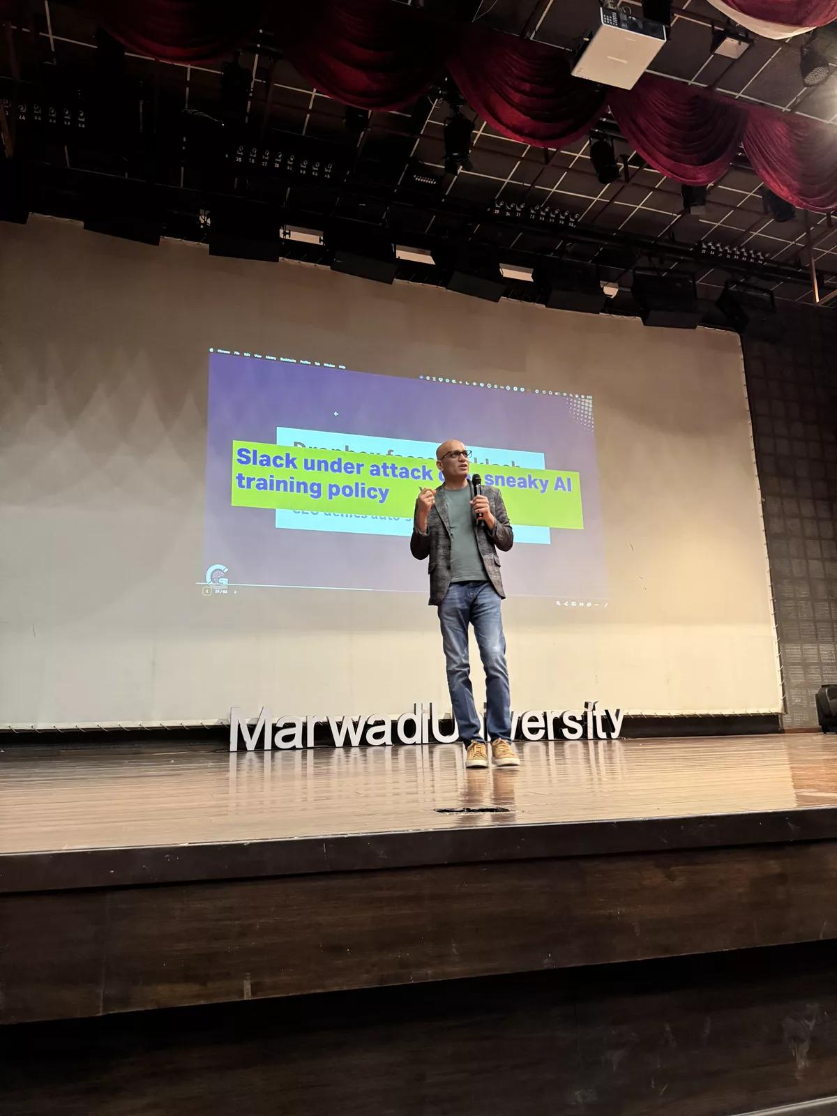 Ritesh Vajariya presenting on stage at Marwadi University in India